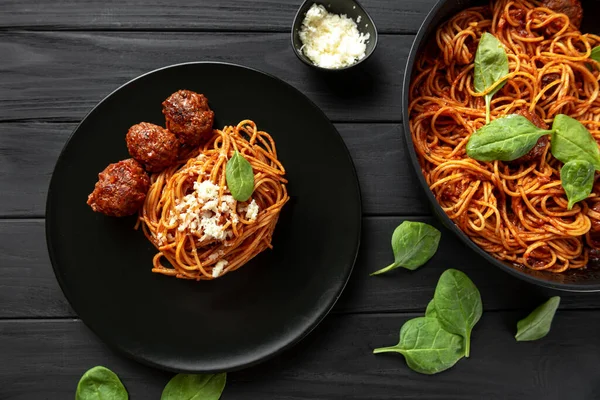 a traditional food in Italy. The classic breakfast, lunch, and dinner of Italians. Spaghetti with meat balls on a dark background.