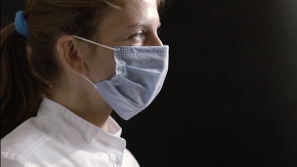Female Doctor Nurse Slowly Turns Her Head Looks Camera Black — Vídeo de stock