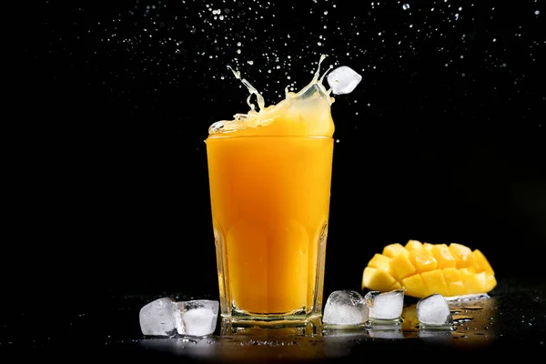 Fresh Mango Juice Splash Mango Cocktail Black Background Ice Cubes Royaltyfria Stockfoton