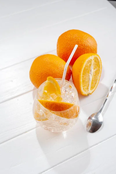 Hard seltzer cocktails Alcoholic beverage with tonic and orange on a light background. Top view.