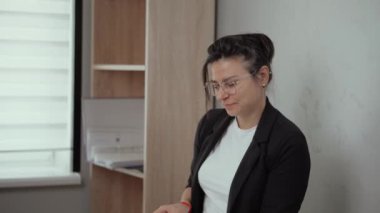 Woman young accountant or manager, office worker works with papers counts, income, expenses, estimates the budget of the project, the accountant conducts financial audits, summarizes the results. The