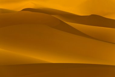 Libya çöl. yoğun altın tozu, tepeleri ve düşük güneş ışığında güzel kumlu yapıları.