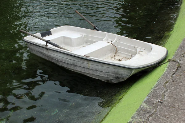 Petit bateau à côté d'une jetée de béton — Photo