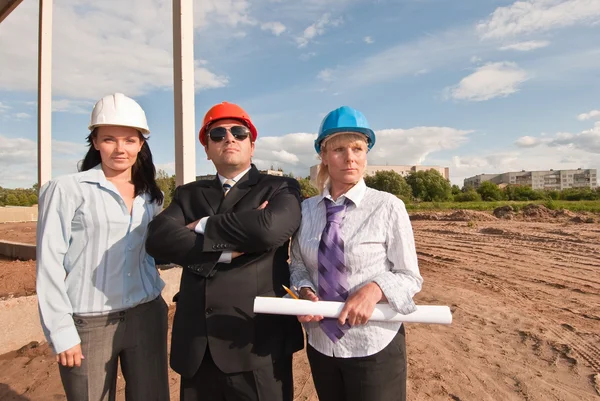 Director with subordinates on construction site — Stock Photo, Image