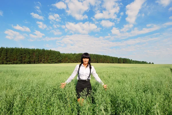 Attractive happy young woman in the field — Stock Photo, Image