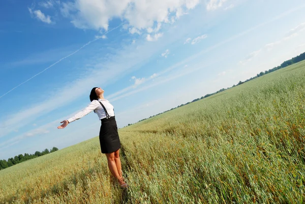 Attractive happy young woman in the field — Stock Photo, Image