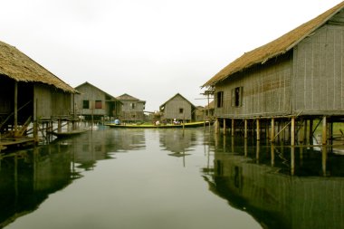 stilt houses on lake clipart