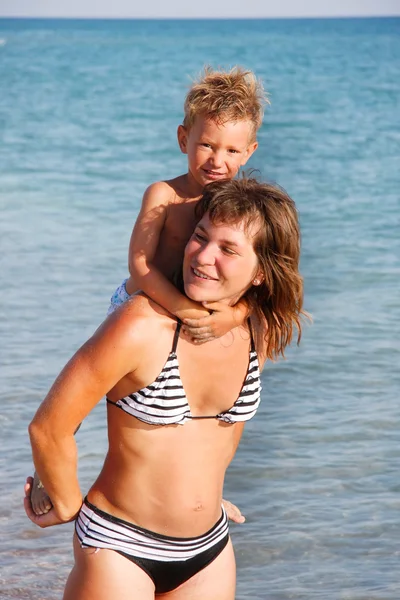 Happy mother and son on sea background — Stock Photo, Image