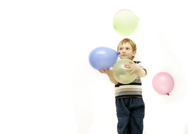 Junge mit bunten Luftballons über Weiß — Stockfoto