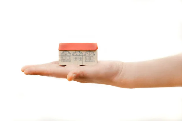 Toy house on human hand — Stock Photo, Image