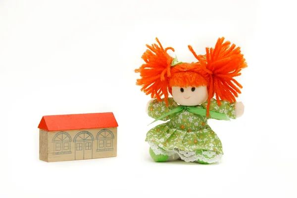 Doll near toy house over white — Stock Photo, Image