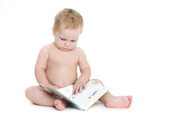 Bébé sérieux avec livre sur blanc — Photo