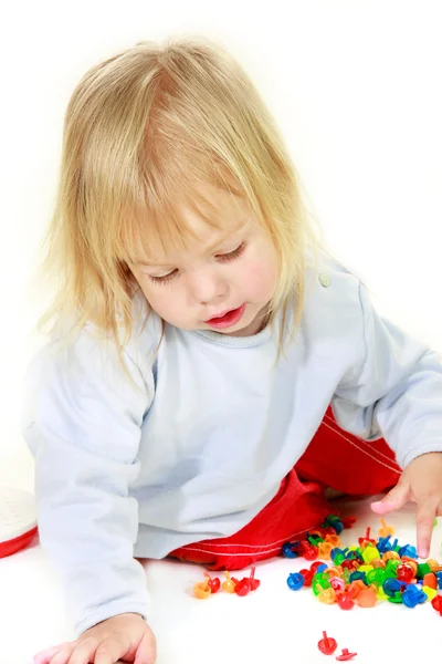 Cute toddler girl with multiple colorful details over white — Stock Photo, Image