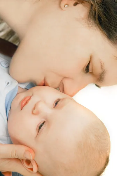 Mother kissing her baby over white — Stock Photo, Image