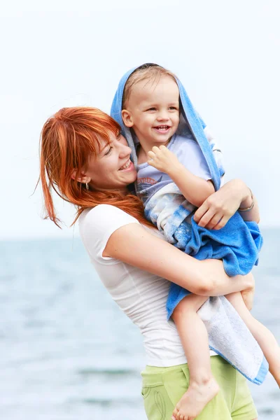 Gelukkig moeder en zoon op strand — Stockfoto