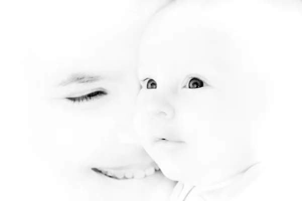 Mother and baby portrait in high-key, focus on baby — Stock Photo, Image