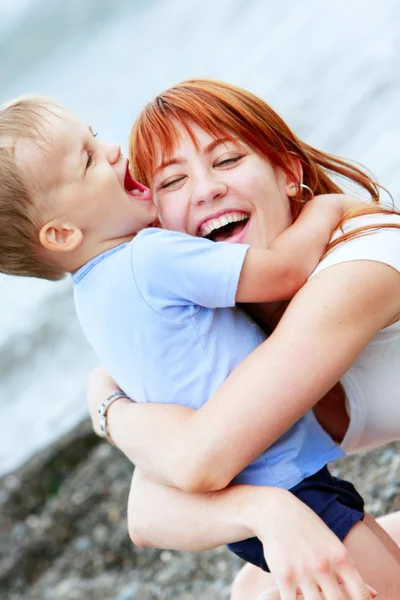Happy mother and son on natural background — Stock Photo, Image
