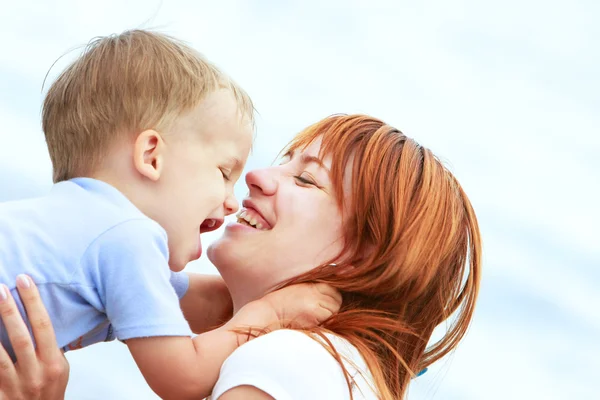 Outdoor portrait of happy mother and son — Stock Photo, Image