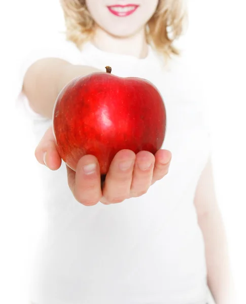 Young girl giving red apple over white — Stock Photo, Image