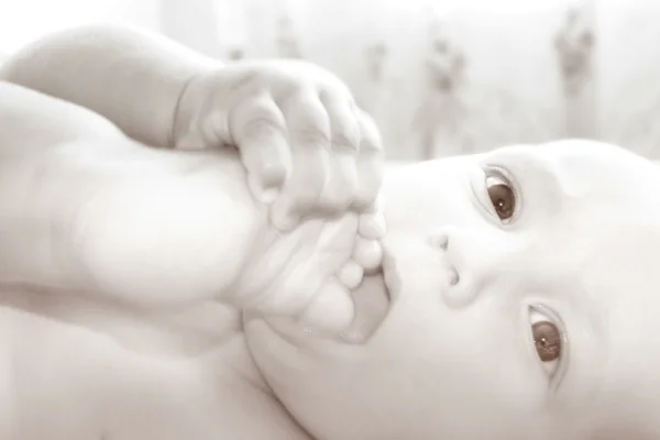 Baby with his foot in mouth — Stock Photo, Image