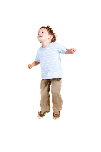Happy young boy jumping over white Stock Image