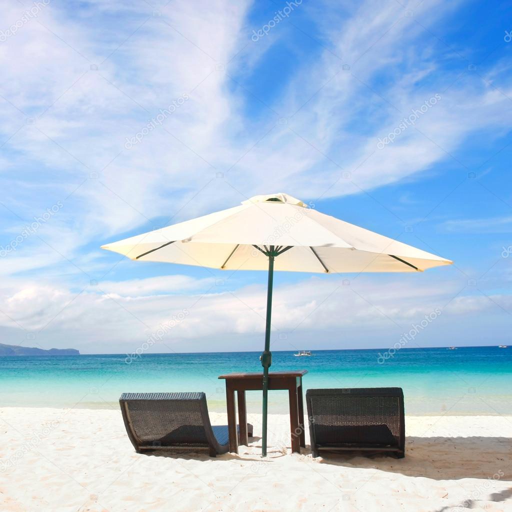 chairs and umbrella on sand beach