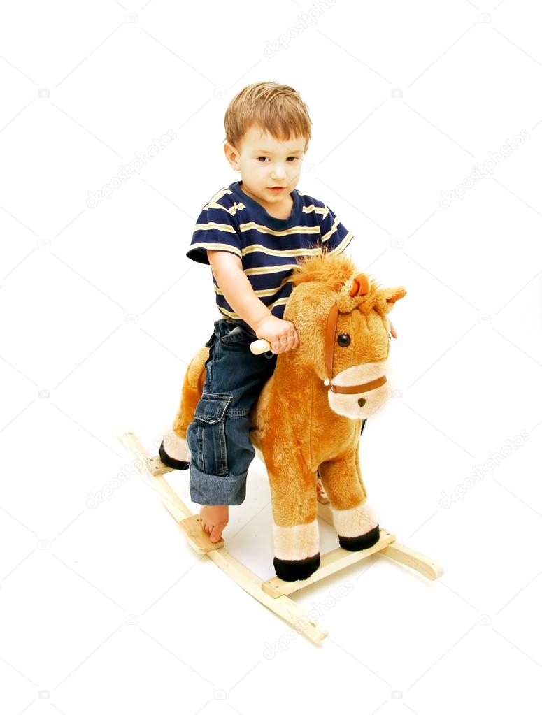 Boy on rocking horse over white