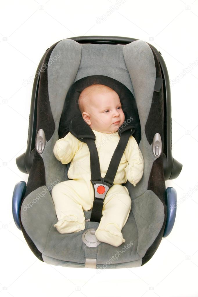 baby in car seat over white
