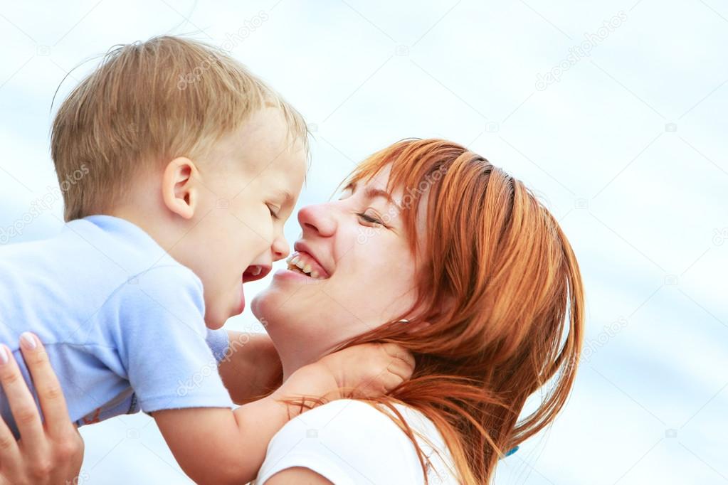 outdoor portrait of happy mother and son