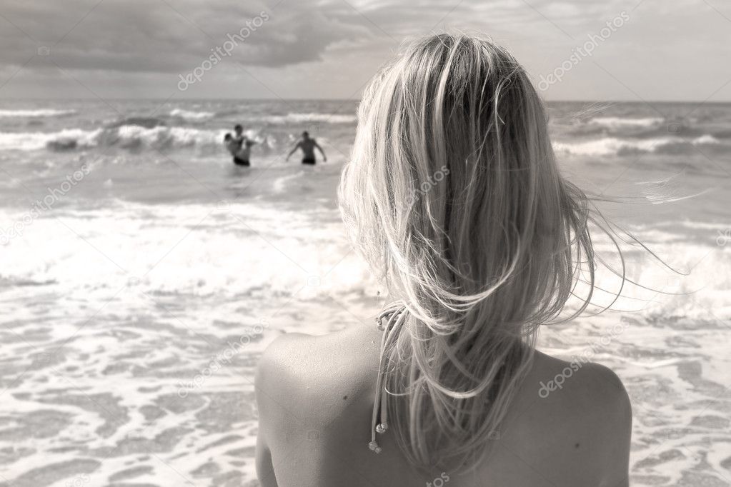 girl looking in the stormy sea