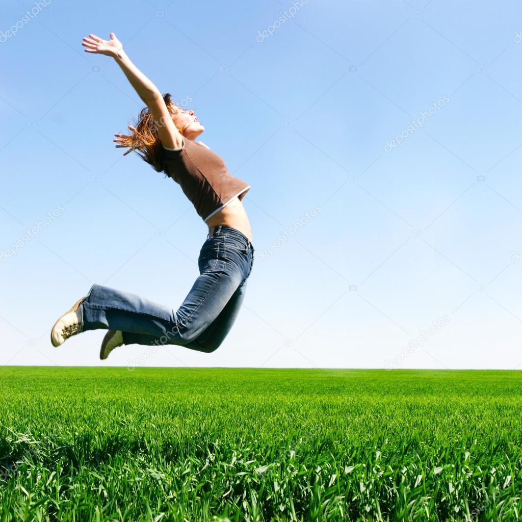 happy girl jumping on natural background