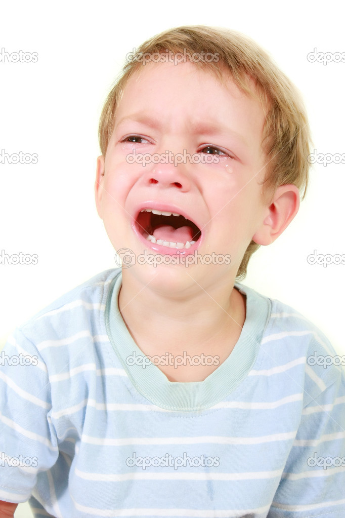 crying toddler boy over white