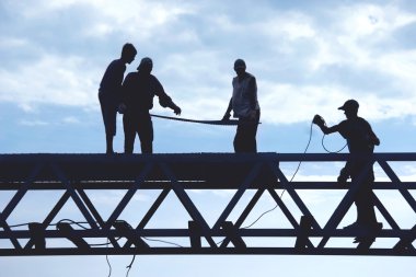 silhouette workers on construction site clipart