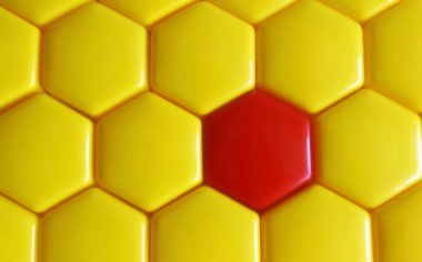 pattern from multiple yellow and one red hexagons
