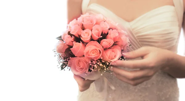 Wedding bouquet in bride's hands over white — Stock Photo, Image