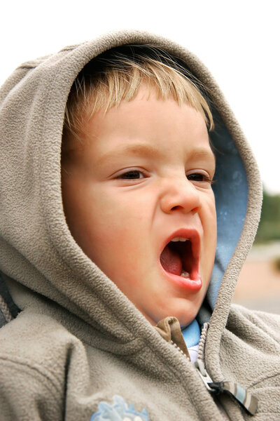 yawning baby-boy partly isolated over white