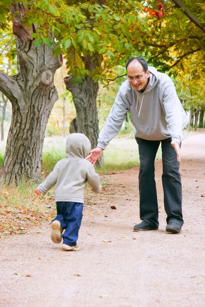 Πατέρας και γιος που παίζει στο πάρκο φθινόπωρο — Φωτογραφία Αρχείου