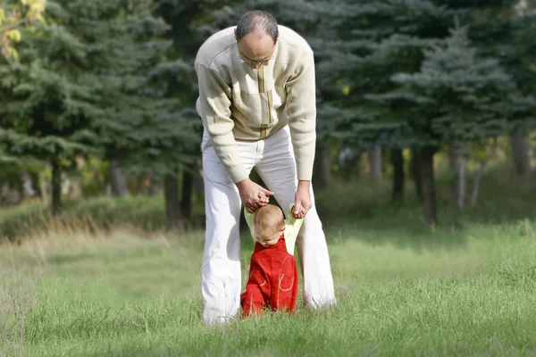 Father and son walking in park — Stock Photo, Image