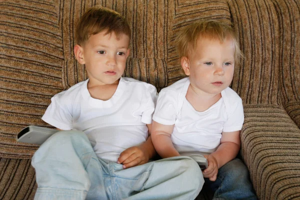 Двое детей смотрят телевизор дома — стоковое фото