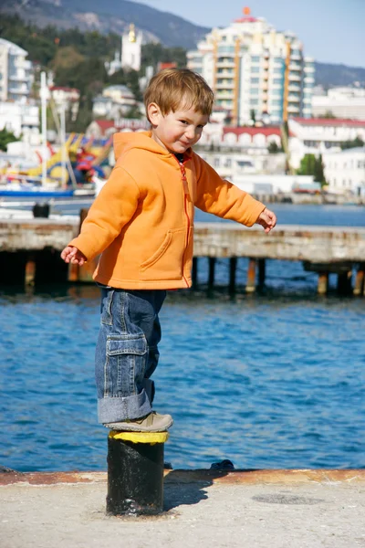 Happy boy on sea city background — Stock Photo, Image