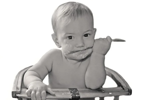 Menino com colher sobre branco — Fotografia de Stock