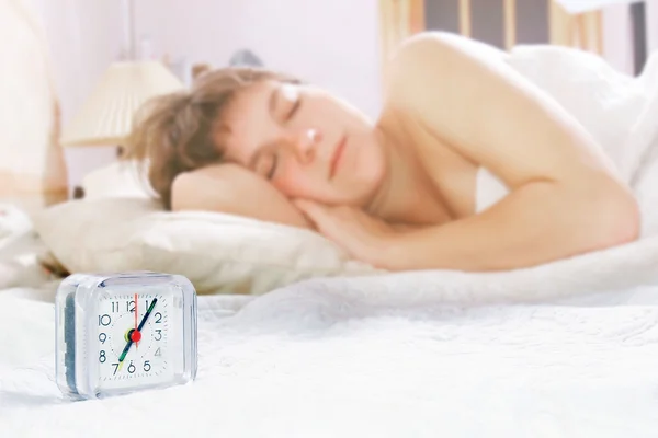 Alarm clock on sleeping girl background — Stock Photo, Image