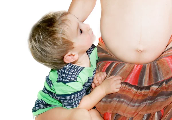 Little boy near pregnant mother over white — Stock Photo, Image
