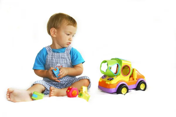 Baby boy playing with toy-truck — Stock Photo, Image