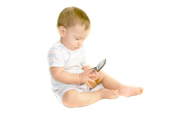 Baby Junge hält ein Handy über Weiß — Stockfoto