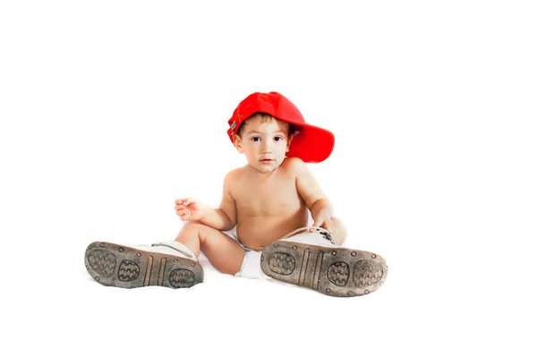 Criança menino em botas dos pais sobre branco — Fotografia de Stock