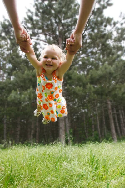 Flying toddler girl on natural background — Stock Photo, Image