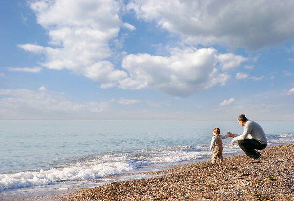 father and son on pebble beach