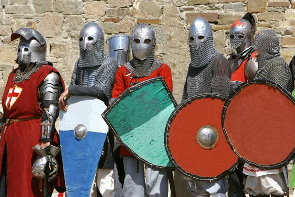 Several knights on stone wall background — Stock Photo, Image