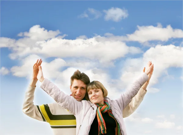 Jovem casal feliz sobre fundo céu — Fotografia de Stock